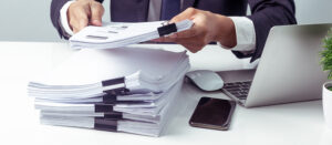 Person with stacks of documents | request HOA documents