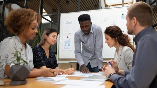 five people meeting at a board room | hoa treasurer duties