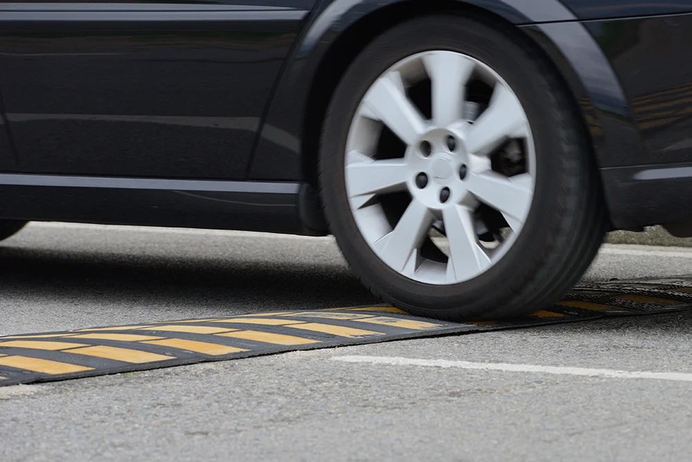 car on a speed bump | speed bumps in HOAs